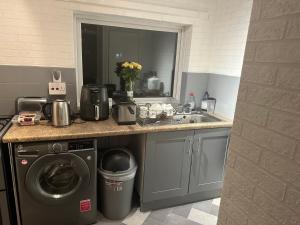 a kitchen with a sink and a washing machine at Double room to rent 2 in Birmingham