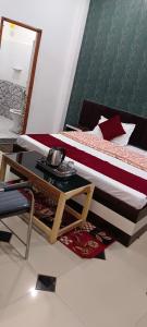 a bedroom with a bed and a coffee table at Shree Gorakhnath Guest House in Ayodhya