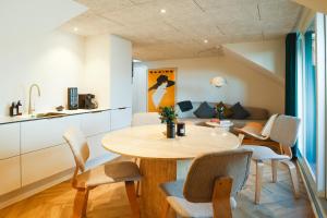 a kitchen and dining room with a table and chairs at STAY Penthouse in Kolding