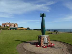 a statue of a large green sculpture in a field at 35 Siesta Mar in Mundesley