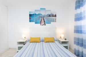 a bedroom with a large bed with yellow pillows at Caletillas Waves & Pool in Candelaria +28 photos
