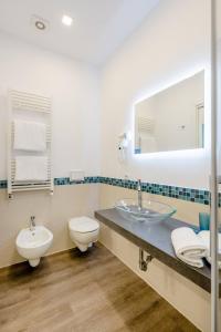 a bathroom with a sink and a toilet and a mirror at B&B Il Saraceno in Sorrento