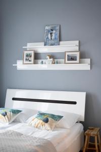 a bedroom with two white shelves above a bed at Apartament Centrum Legnicy Janson in Legnica