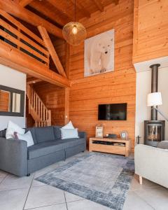 a living room with a couch and a tv at Beautiful 2 bed Chalet Morzine in Morzine