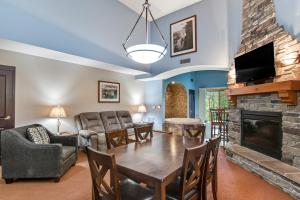 ein Wohnzimmer mit einem Tisch und einem Kamin in der Unterkunft Chula Vista Condo 2145 & 2147 Full Property in Wisconsin Dells