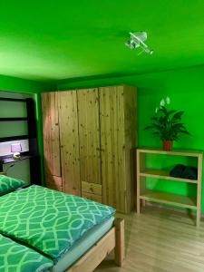 a green bedroom with a bed and a green ceiling at Ciao Amore St. Anton in Sankt Anton am Arlberg
