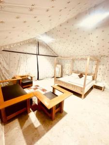 a room with two beds and a table in a tent at K's Villa Bella in Bhuj