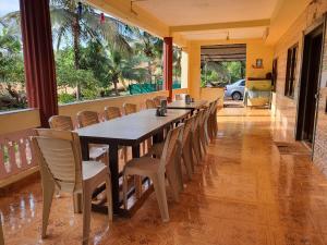 a long dining room with a long table and chairs at Kshudha-Shanti Homestay (MTDC-Approved) in Ratnagiri