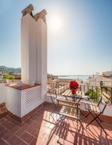 a balcony with a table and chairs and a view at Blue Home in Sitges