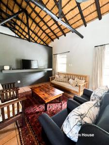 a living room with a couch and a table at 24 Degrees South Country Estate in Hoedspruit