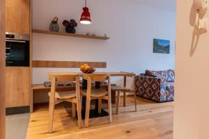 a kitchen and dining room with a table and chairs at Apartments Nomad Bjelašnica in Bjelašnica