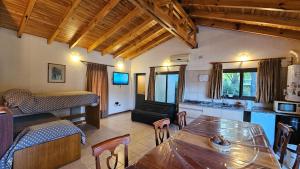 a living room with a bed and a dining room at Cabaña de Encanto in San Rafael