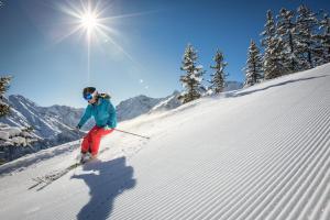 a woman is skiing down a snow covered slope at Appartement Valbona Blick by A-Appartments in Bürserberg