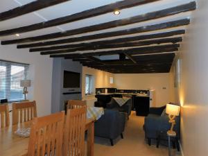 a dining room and living room with a table and chairs at Anchor Cottage, Sheringham - Keys Holiday Cottages in Sheringham