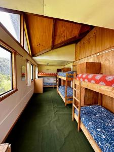 a room with two bunk beds in a train at Hostal Las Natalias in Futaleufú