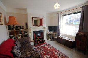 a living room with a couch and a fireplace at Annies, 30 Station Road in Sheringham