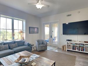 a living room with a couch and a table at Redfish Village m2-430 in Blue Mountain Beach