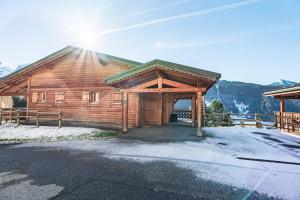 a log cabin with the sun shining on the roof at Beautiful 2 bed Chalet Morzine in Morzine