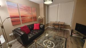 a living room with a leather couch and a table at The Savile, Luxury Apartment Leeds - Your Next Stay in Leeds