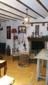 a living room with a fireplace and a table at Pensión Alfin in Granada