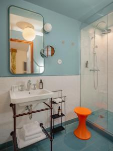a bathroom with a sink and a shower at Hôtel Saint-André des Arts in Paris