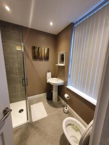 a bathroom with a shower toilet and a sink at The Savile - Luxury Apartment Leeds - Your Next Stay in Leeds