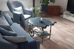 a living room with a couch and a coffee table at DG-Ferienwohnung in Leubsdorf