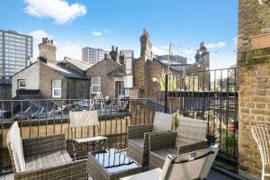 a balcony with two chairs and a table at Central Hackney Abode - Balcony in London