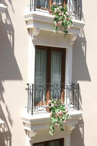 a white building with flowers on a balcony at Belle Maison Hotel&Residence in Istanbul