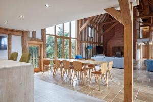 a kitchen and dining room with a table and chairs at Mulberry Barn, Great Sampford in Great Sampford