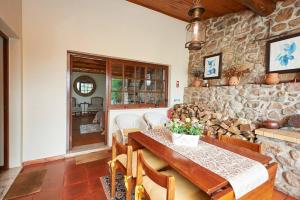 a dining room with a table and a stone wall at Casa do Moinho in Ulgueira