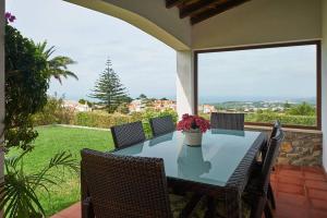 a table and chairs on a patio with a view at Casa do Moinho in Ulgueira