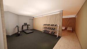 a room with a gym with a treadmill in it at Amelie No 3 Hotel & Appartements in Schweigen-Rechtenbach