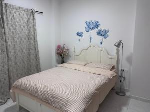 a bedroom with a bed with a blue flower mural on the wall at Pireas new hotel in Piraeus