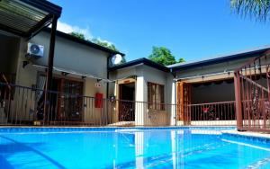 a house with a swimming pool in front of it at Red Apple Guest House in Pretoria