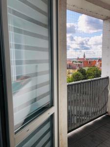 a window of a balcony with a view of a city at Apartament Panorama miasta in Olsztyn