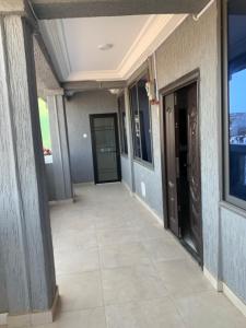 a hallway of a building with a door at CRL Apartment in Tema