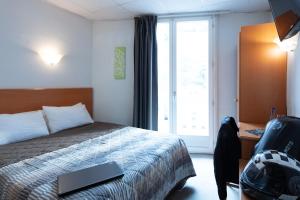 Postel nebo postele na pokoji v ubytování Hôtel Compostelle