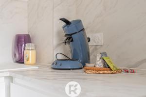 a blue coffee maker on a counter in a kitchen at L'Authentic Green in Grenoble