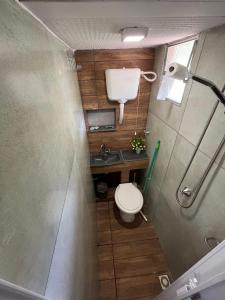 a small bathroom with a toilet and a sink at Hostel Sossego do Garças in Barra do Garças