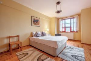 a bedroom with a bed and a chair in it at Villa with Garden 10 min to Sapanca Lake in Izmit