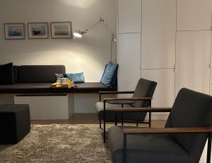 a living room with a couch and a table and chairs at Inselloft-Rügen in Binz
