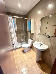 a bathroom with a toilet and a sink at Large Apartment in el Raval in Barcelona