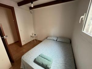 a small bedroom with a bed and a window at Large Apartment in el Raval in Barcelona