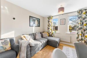 a living room with a couch and a window at Designer Apartment - Great Location! in Manchester