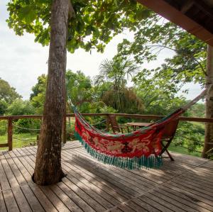 eine Hängematte auf einer Terrasse mit einem Baum in der Unterkunft Aite Eco Resort in Palomino