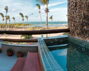 a resort with a swimming pool and a beach at Locanda dei Venti in Itarema