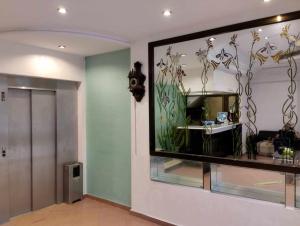 a room with a large window with flowers on the wall at Hotel yasmine in Sfax