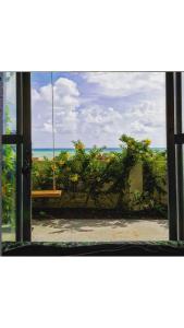 an open window with a view of the ocean at Casa de Mar Sagi in Baía Formosa