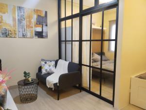 a living room with a couch and a bedroom at C516 Place at SMDC Cheer Residences by Lee Portum in Marilao